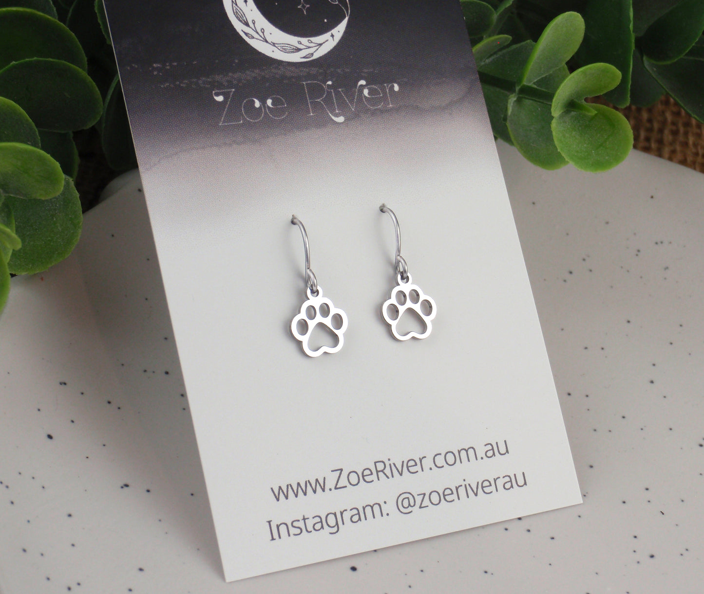 Tiny silver pawprint earrings. Choose from Stainless steel, nickel free titanium or 925 sterling silver earwires. Small paw print earrings
