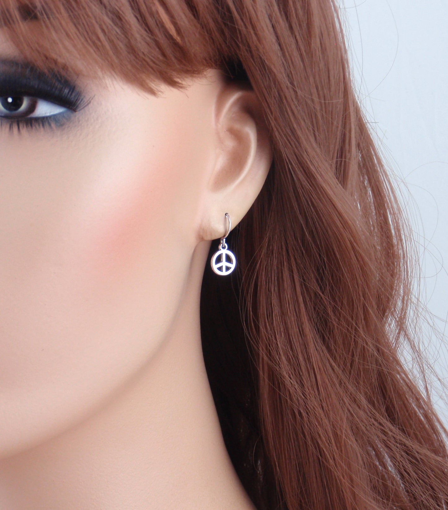 Tiny silver peace sign earrings. Choose from Stainless steel, nickel free titanium or 925 sterling silver earwires. Small peace sign earrings