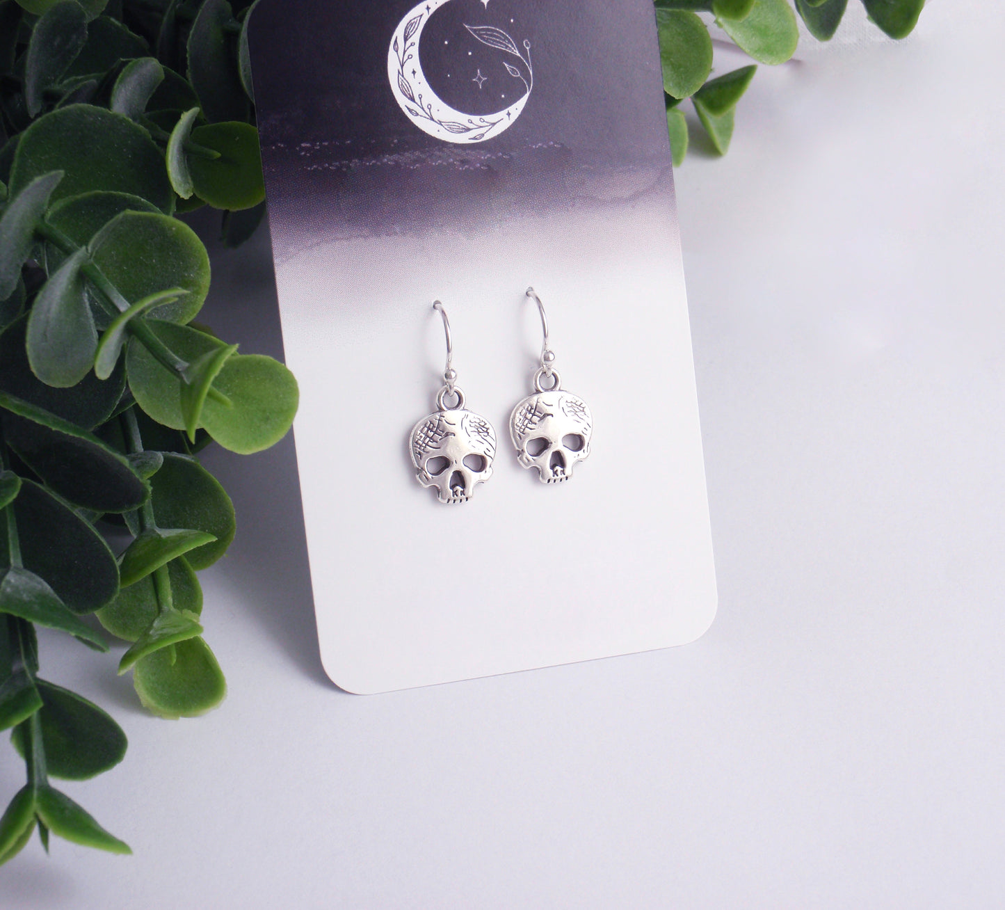 Dainty skull earrings with your choice of 925 sterling silver, stainless steel or titanium earposts. Halloween earrings, small tiny silver