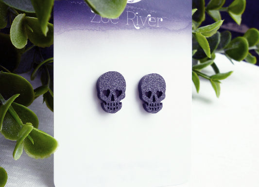 Black glitter skull stud earrings with your choice of 925 sterling silver, stainless steel or titanium earposts. Halloween earrings